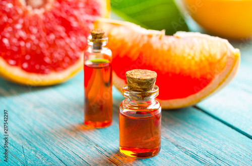 citrus oil cosmetic grapefruit medicine health nature glass vial wooden background
