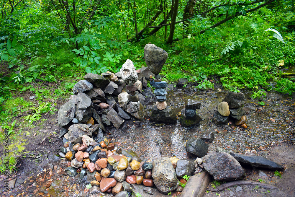 The unusual shape of the stones. Stone tower against the forest. River stone. Stream in the forest. The unusual shape of the stones. Stone tower against the forest. River stone. Stream in the forest.