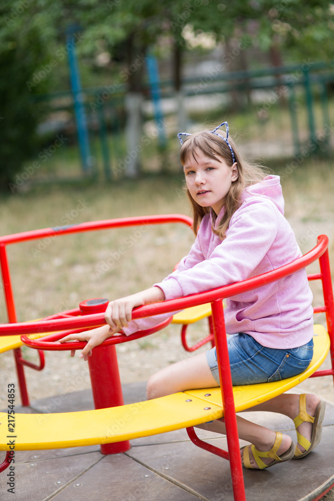 Fototapeta premium teenage girl is engaged in children's exercise equipment