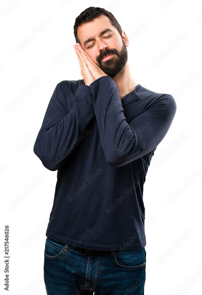 Handsome man with beard making sleep gesture Handsome man with beard making sleep gesture