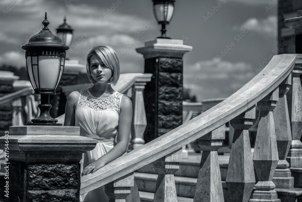 Fototapeta premium Portrait of a beautiful young woman outdoors. Black and white photo