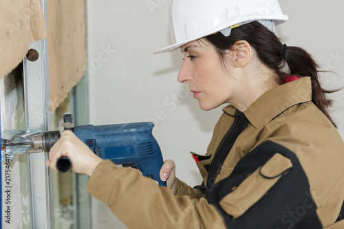 woman drilling hole using circular attachment