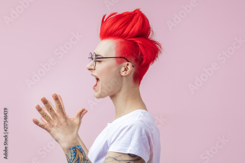 good looking girl with nonstandard appearance clapping her hands. joy and happiness concept photo