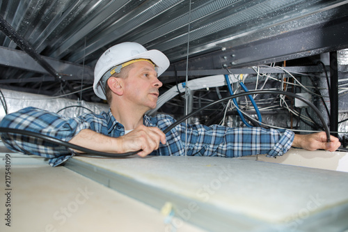 electrician wiring an industrial loft space