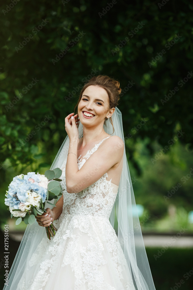 Pretty happy bride in luxury dress with bouquet of roses. Pretty happy bride in luxury dress with bouquet of roses.
