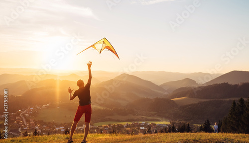 Father and son start to fly a kite together photo