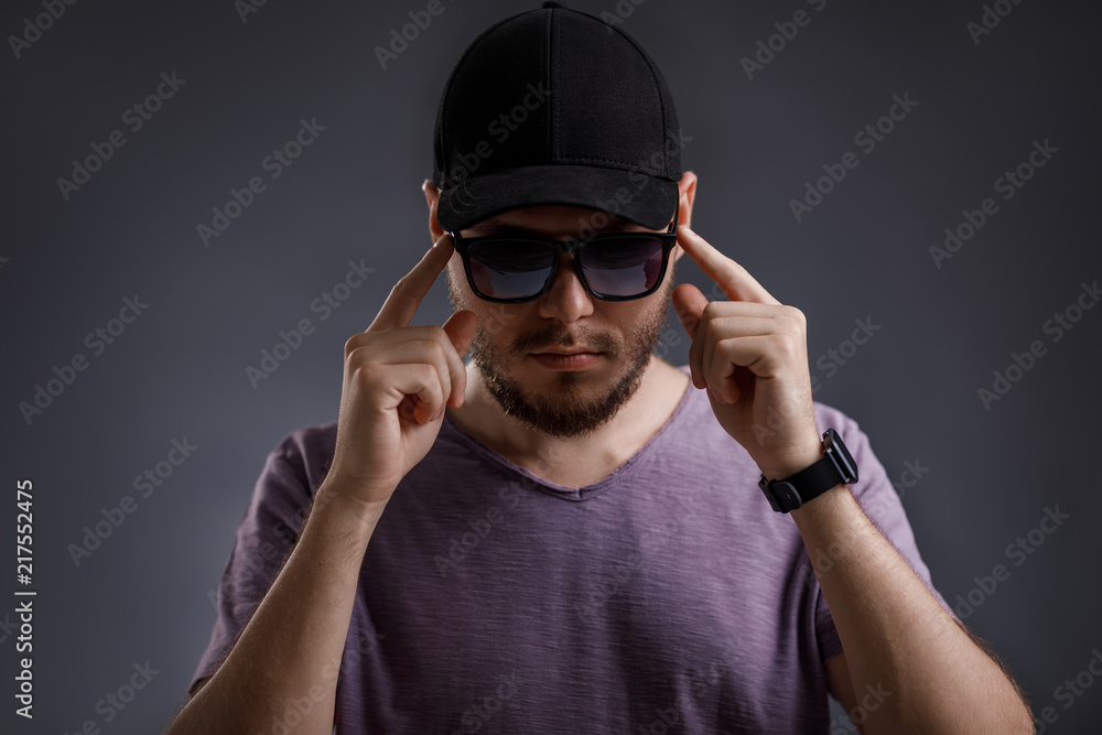 young bearded man in cap and sunglasses young bearded man in cap and sunglasses