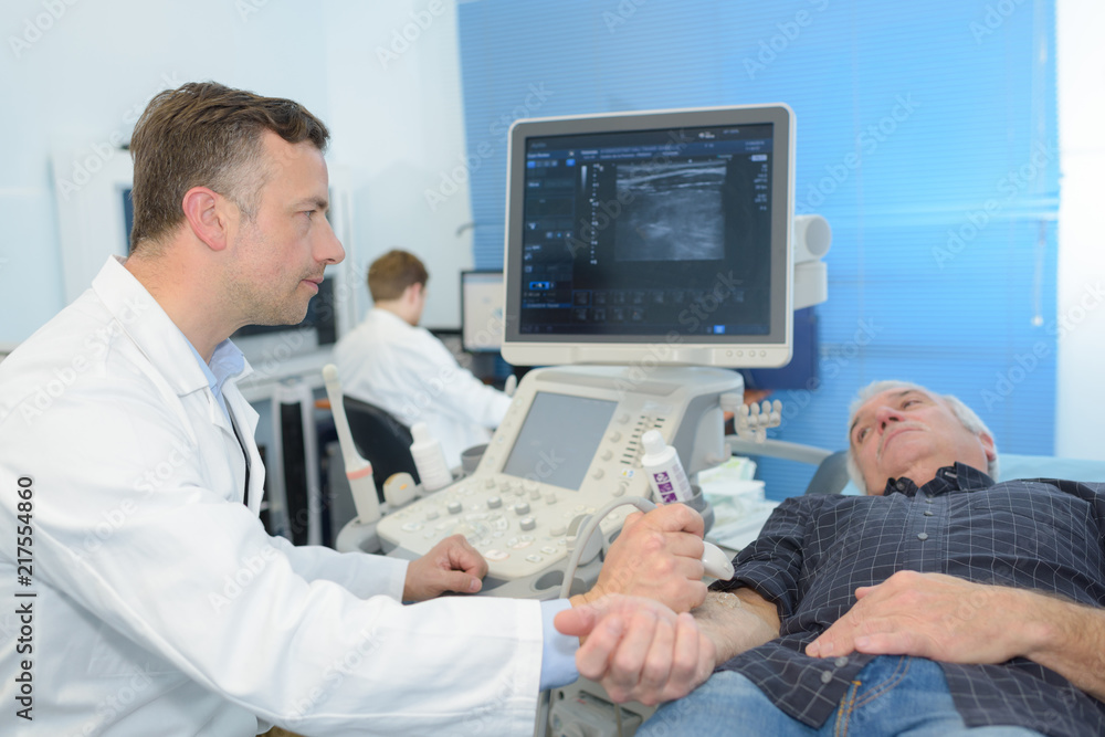 man diagnosed at ultrasound device in a hospital man diagnosed at ultrasound device in a hospital