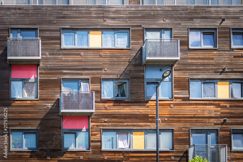 Wooden residental building in Greenford (London) with yellow and red balconies
