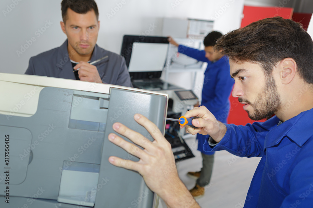 Technician unscrewing appliance Technician unscrewing appliance