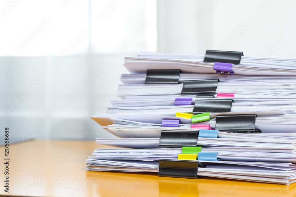 Stacks of office working paper documents files with black clip. Stacks of office working paper documents files with black clip.