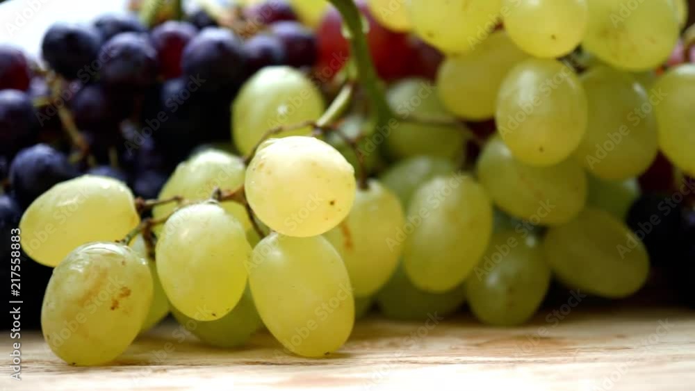 Fresh organic grapes collection with water drops rotating on a turn table. Macro. 4K Fresh organic grapes collection with water drops rotating on a turn table. Macro. 4K