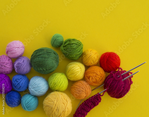 ball for knit rainbow color a yellow background.