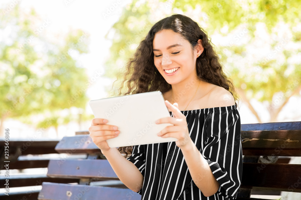 Happy girl reading with e-reader