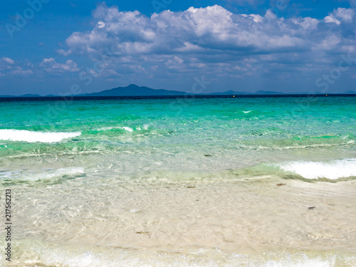 emerald ocean and cloudy sky