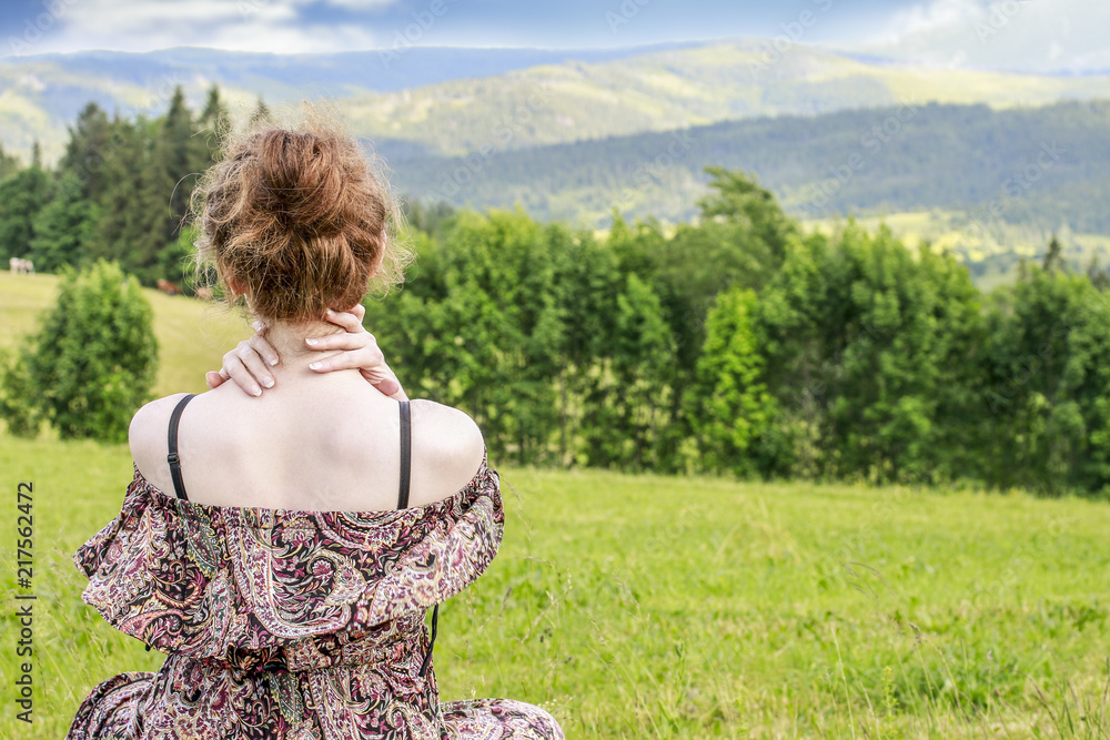Young woman sitting on grass, alpine landscape. Young woman sitting on grass, alpine landscape.