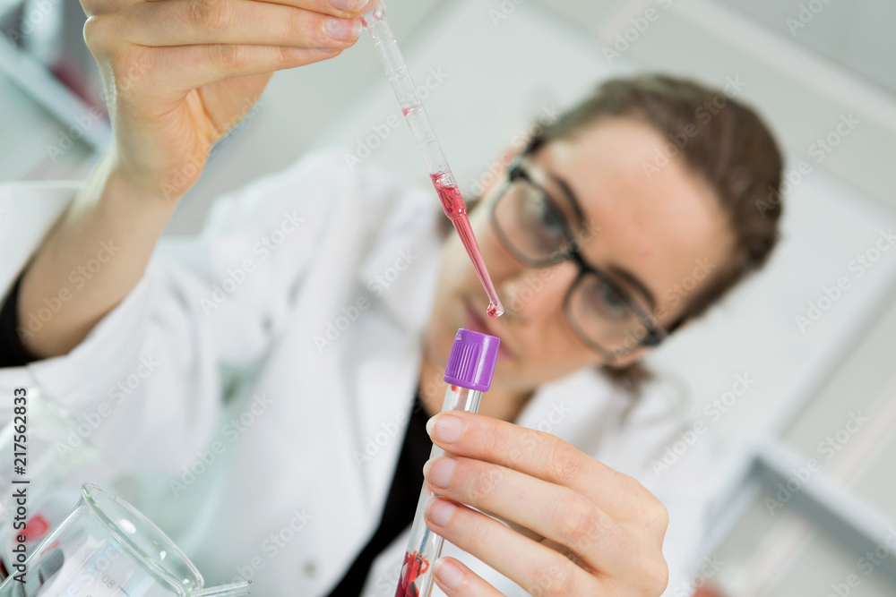 concentrated scientist pouring fluid concentrated scientist pouring fluid