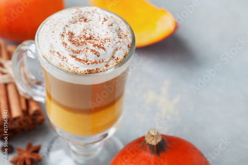 Pumpkin spiced latte or coffee in glass. Autumn, fall or winter hot drink.