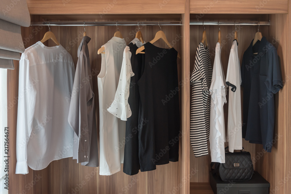 modern walk in closet with clothes