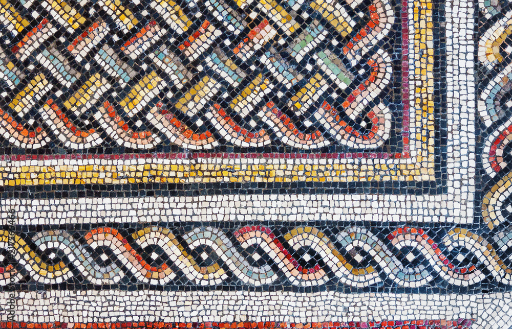 Colorful small tiles of an ancient floor mosaic, geometric ornament background