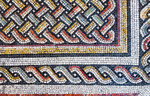 Colorful small tiles of an ancient floor mosaic, geometric ornament background