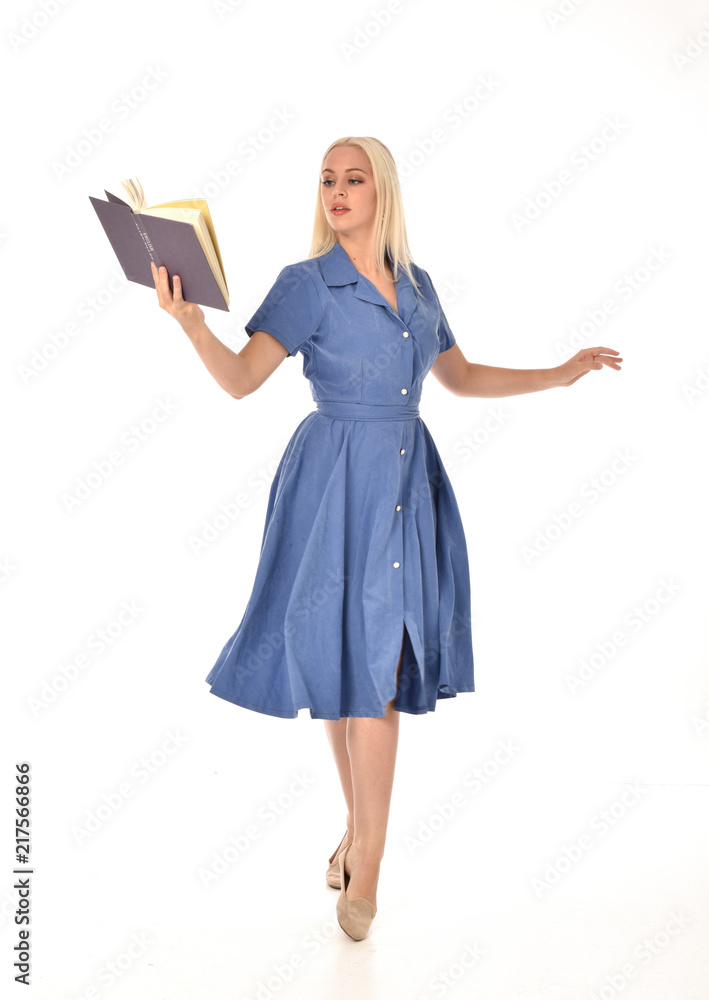 full length portrait of blonde girl wearing blue dress. standing pose