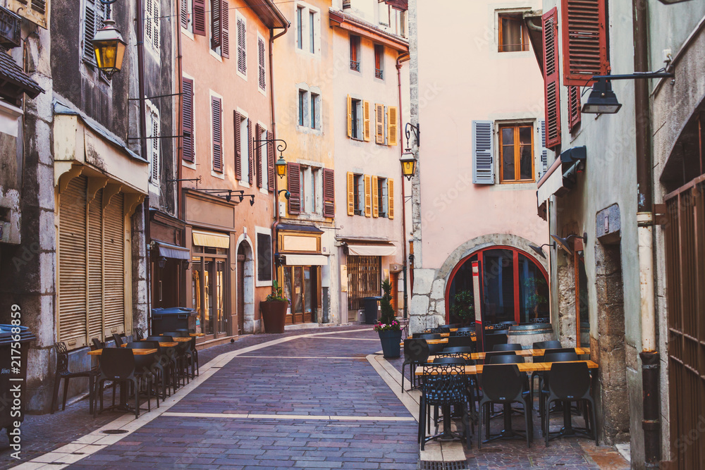 Annecy old town, historical buildings in city center, landmark architecture, cozy street in France with cobblestone pavement and sidewalk restaurants