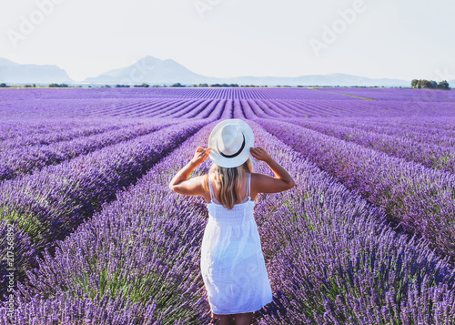 Fototapeta Naklejka Na Ścianę i Meble -  dream and inspiration, summer happy woman in romantic white dress enjoying nature in lavender flowers fields