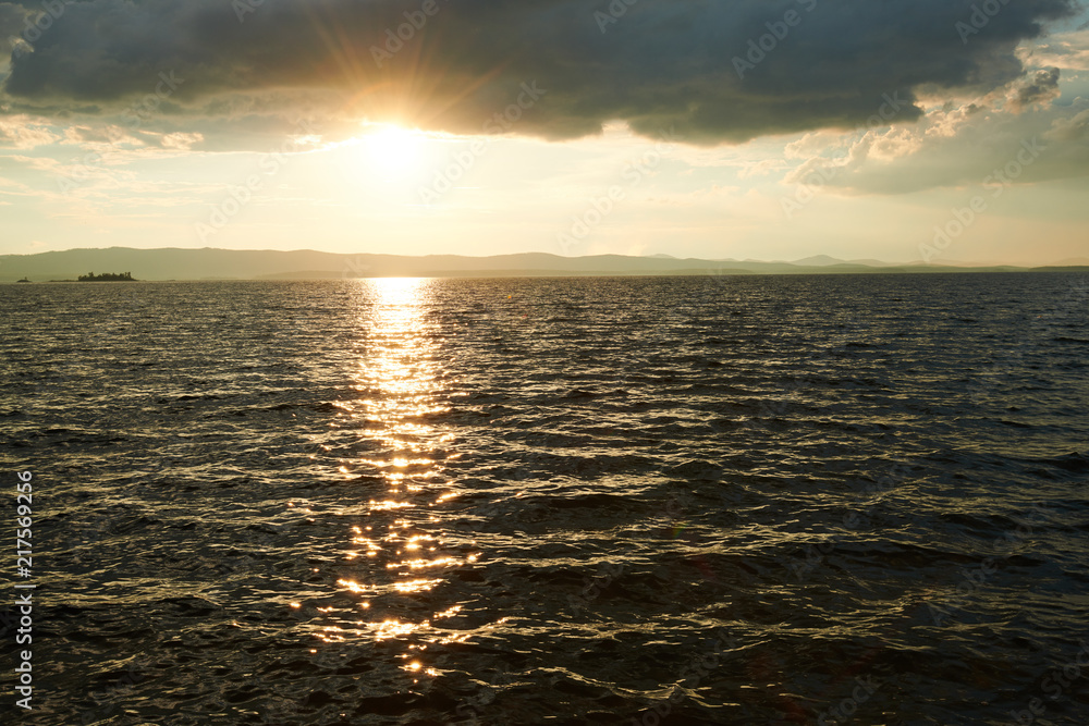 Fototapeta premium Beautiful sunset on the lake with cloudy sky