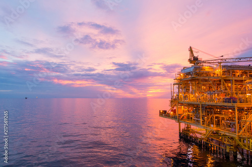 Offshore construction platform for exploration and production oil and gas with bridge in evening time for power energy of the world concept