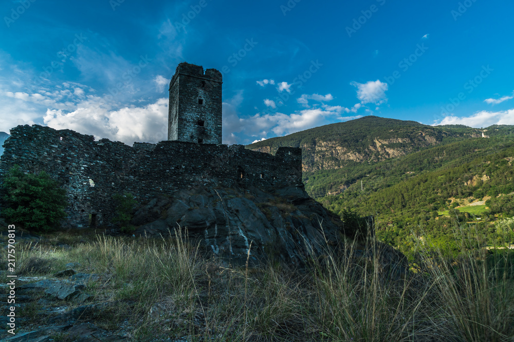 medieval castle in valle d'aosta italy on alps mountains cloudy sky sunset medieval castle in valle d'aosta italy on alps mountains cloudy sky sunset