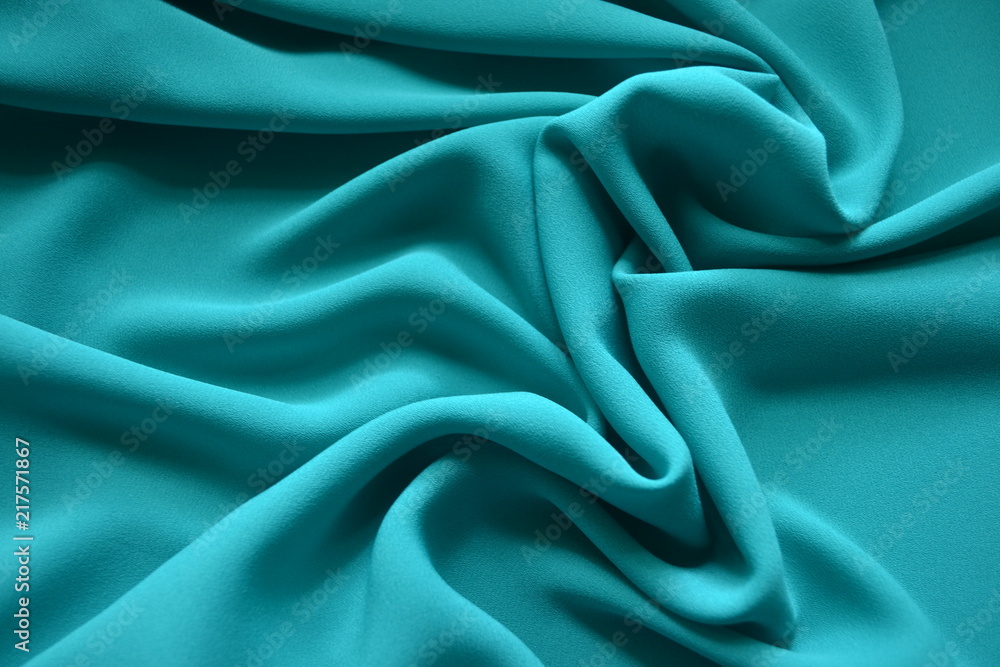 Bright fabric of the color of light sea wave, draped with waves Bright fabric of the color of light sea wave, draped with waves