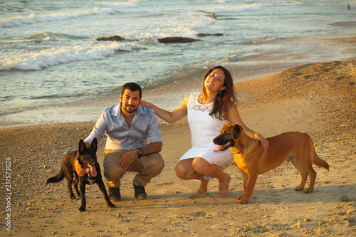 Photography Romantic couple with two dogs at the beach