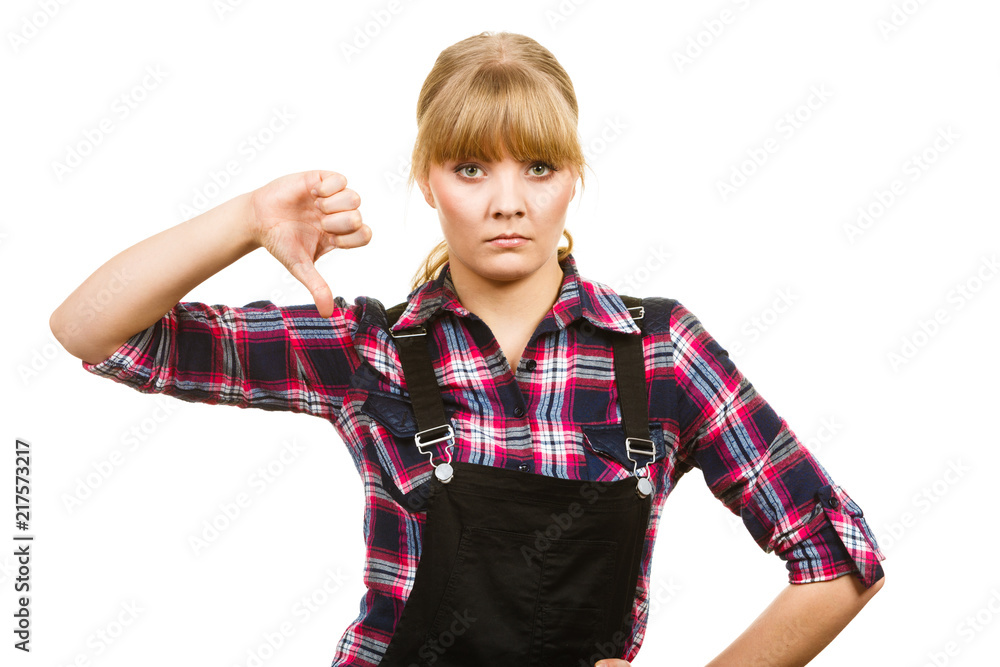 Woman in dungarees showing thumb down Woman in dungarees showing thumb down