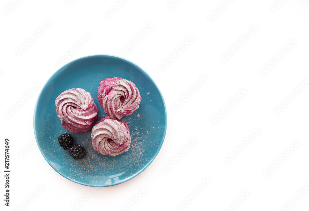 Three pink marshmallows on a blue plate Three pink marshmallows on a blue plate