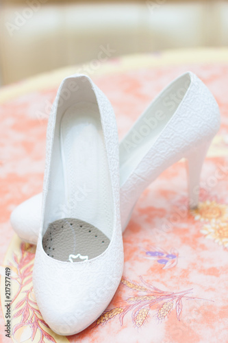 Wedding white female shoes on a blurry background