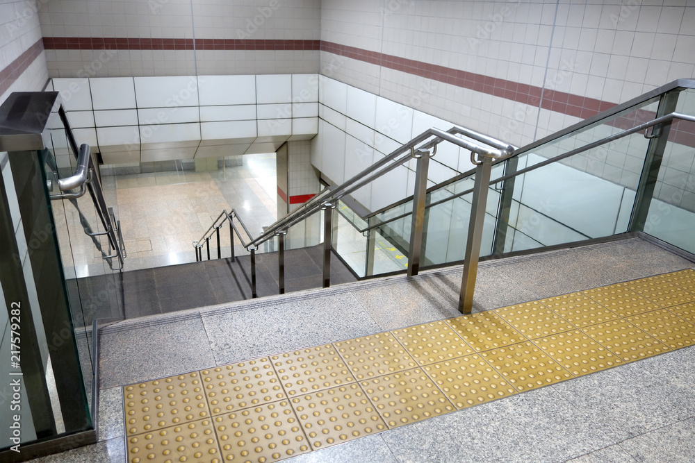 yellow braille block tile and gray marble granite stairs and stainless ...