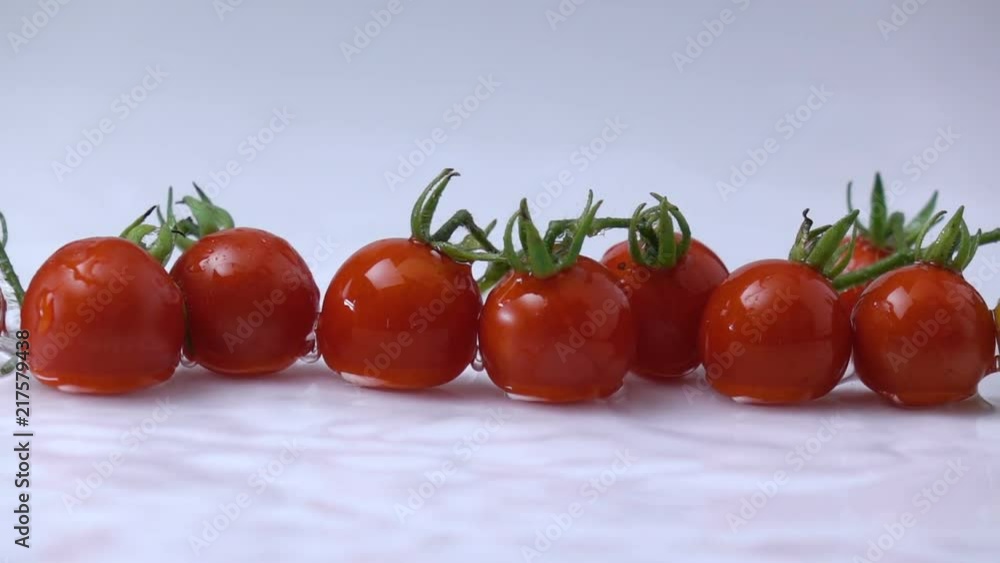 water splashing on a tomato fruit in slow motion. water splashing on a tomato fruit in slow motion.
