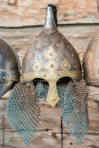 Replica of a medieval warrior Viking helmets on the wooden wall background.