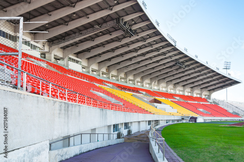 Empty orange and yellow seats at stadium,Rows walkway of seat on a soccer stadium