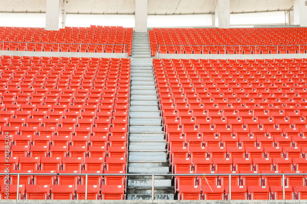 Naklejka premium Empty orange seats at stadium,Rows walkway of seat on a soccer stadium