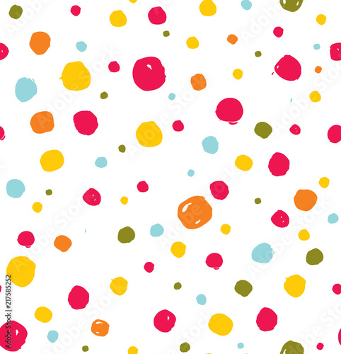 Seamless pattern of cute hand drawn bright colored polka dots.