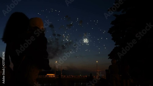 Mother and daughter watching fireworks.