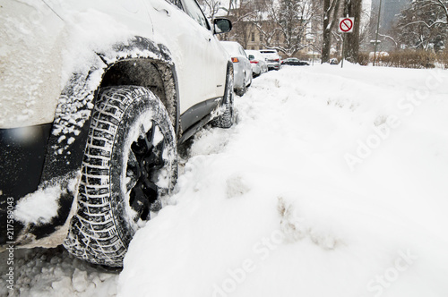 Low angle view of car stuck in deep snow conceptual snow storm and winter weather safety photography