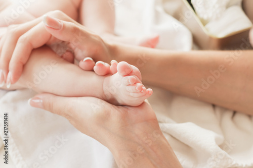 Hands of woman holds baby foot © lisssbetha