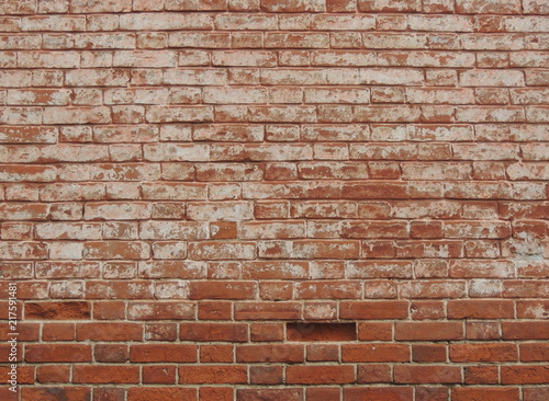 Old red brick wall texture background with peeled white plaster.
