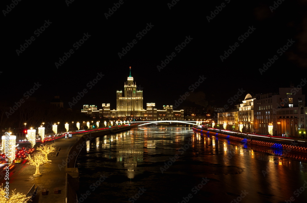 Christmas illuminations on Moskvoretskaya and Raushskaya embankments. High-rise building on Kotelnicheskaya embankment, Moscow, Russia