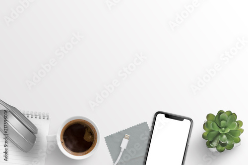Office desk composition with headphones, notepad, cup of coffee, charger, cloth, smart phone and plant. Free space for text.