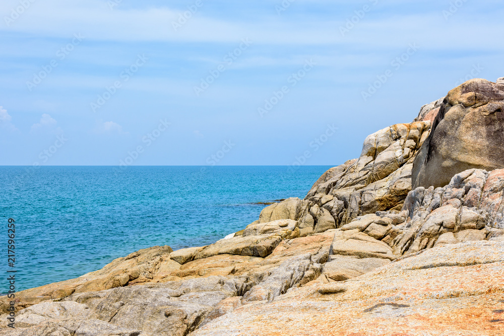 Beautiful natural landscape of rock along the coastline with blue sea under the summer sky at Koh Samui island, Surat Thani province, Thailand