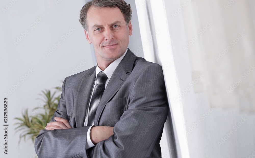 successful businessman on background of office. successful businessman on background of office.
